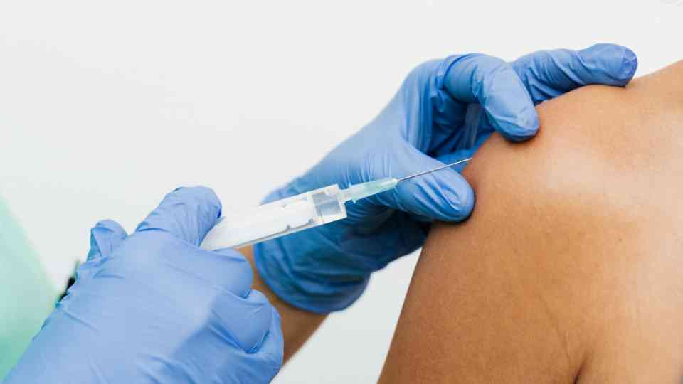 person receiving vaccine in their arm